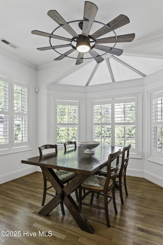dining space featuring dark wood finished floors, baseboards, crown molding, and visible vents