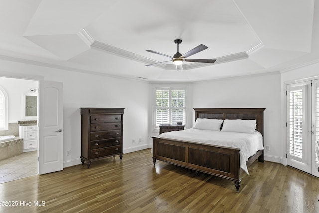 bedroom featuring crown molding, light wood finished floors, and a raised ceiling
