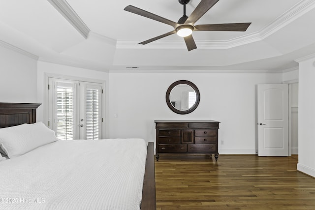 bedroom with crown molding, wood finished floors, access to outside, and a raised ceiling