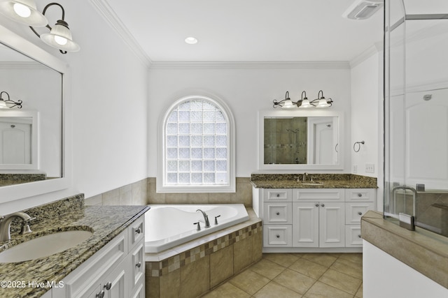 bathroom featuring tile patterned flooring, a shower stall, crown molding, and a sink