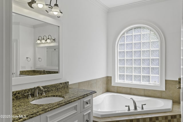 bathroom with a garden tub, vanity, and ornamental molding
