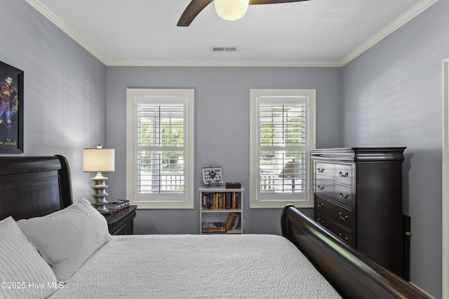 bedroom featuring ceiling fan, ornamental molding, multiple windows, and visible vents