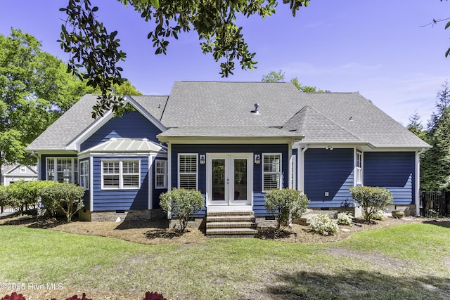 rear view of property featuring french doors, a lawn, crawl space, and a shingled roof