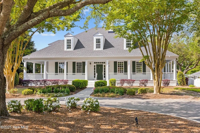 view of front of property featuring a porch and roof with shingles