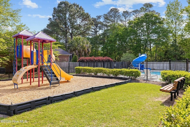 community playground with a fenced in pool, a lawn, and fence