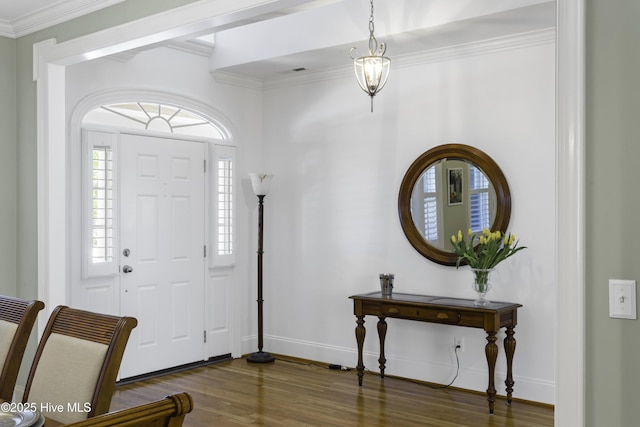 entryway with ornamental molding, baseboards, dark wood-style flooring, and visible vents