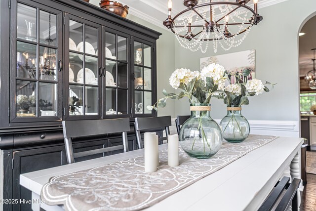 180 Cashew Loop, Cameron, NC 28326 - interior details with crown molding, arched walkways, and a notable chandelier