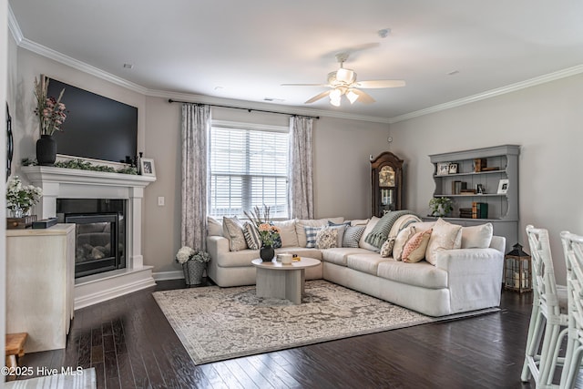 180 Cashew Loop, Cameron, NC 28326 - living room featuring crown molding, a glass covered fireplace, baseboards, dark wood-type flooring, and a ceiling fan