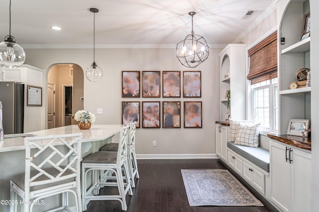 180 Cashew Loop, Cameron, NC 28326 - interior space with visible vents, arched walkways, dark wood-style floors, a notable chandelier, and ornamental molding