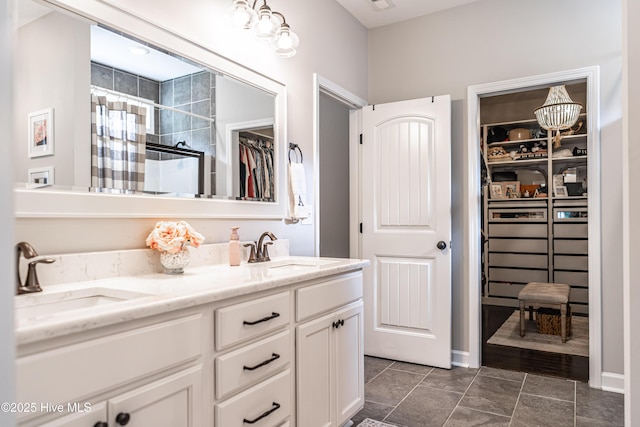 180 Cashew Loop, Cameron, NC 28326 - full bathroom with double vanity, a walk in closet, tiled shower, and a sink