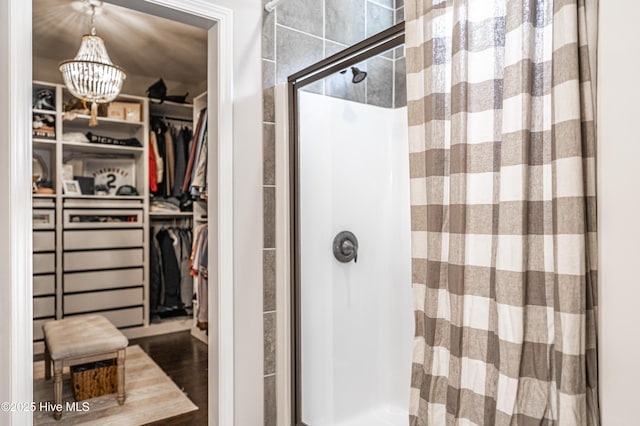 180 Cashew Loop, Cameron, NC 28326 - full bathroom with a spacious closet, a shower stall, wood finished floors, and a chandelier