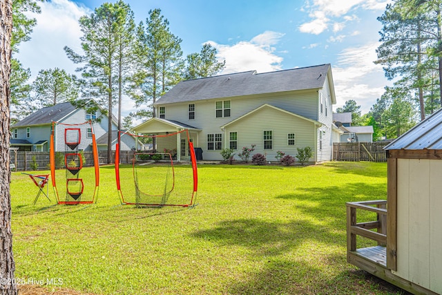 180 Cashew Loop, Cameron, NC 28326 - rear view of house featuring a lawn and a fenced backyard