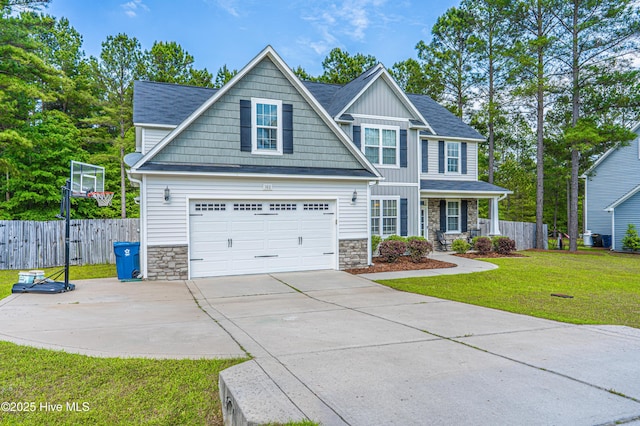 180 Cashew Loop, Cameron, NC 28326 - craftsman house featuring board and batten siding, a front yard, fence, and stone siding
