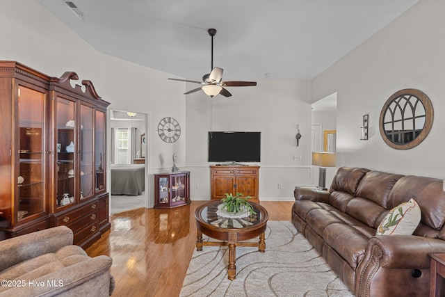 living area with light wood finished floors and a ceiling fan