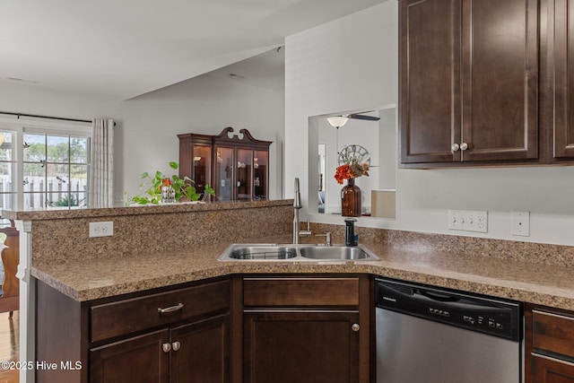 kitchen featuring dishwasher, a sink, dark brown cabinetry, and a peninsula