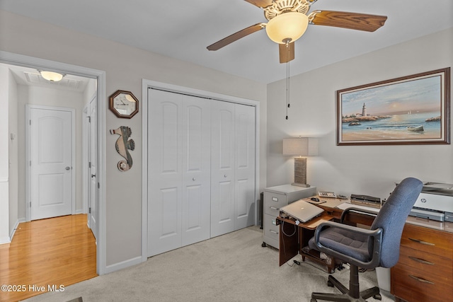 office space featuring ceiling fan and light colored carpet