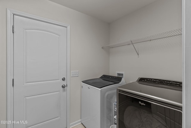 clothes washing area featuring washer and dryer