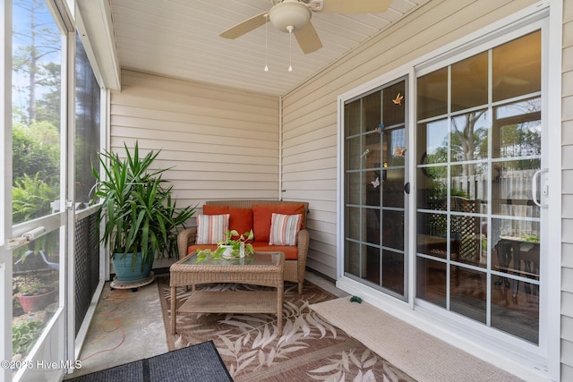 sunroom featuring a ceiling fan and outdoor lounge area
