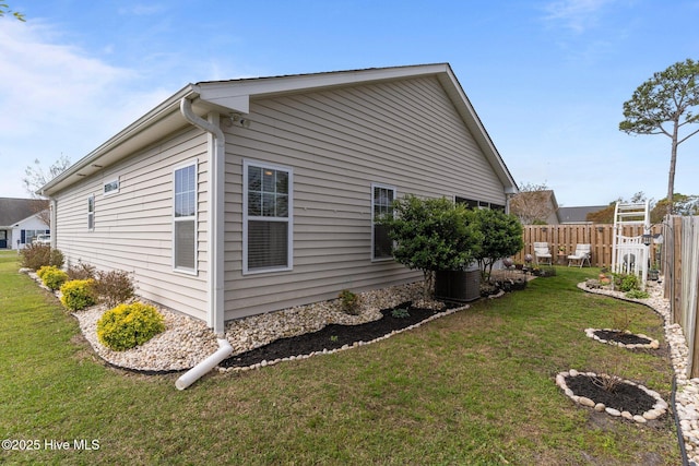 view of side of home with central AC
