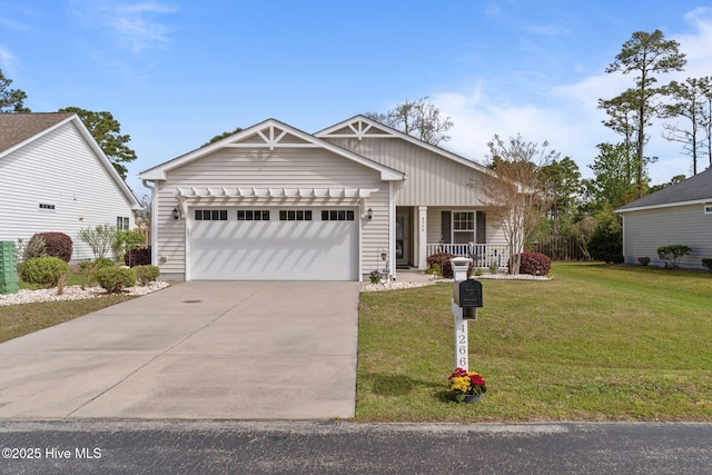 view of front of house with covered porch, a garage, concrete driveway, and a front lawn