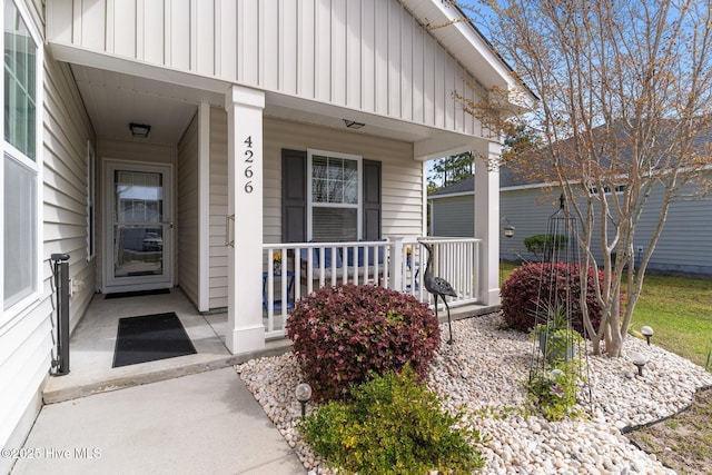 entrance to property featuring board and batten siding and covered porch