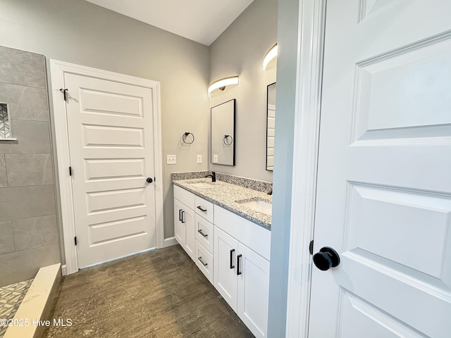 GEORGETOWN Spinnaker Dr, Elizabeth City, NC 27909 - bathroom with a sink, double vanity, wood finished floors, and tiled shower