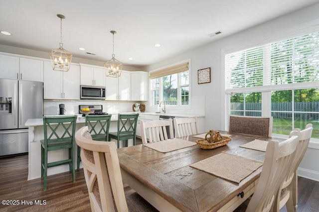 dining room featuring visible vents, recessed lighting, a chandelier, and dark wood finished floors