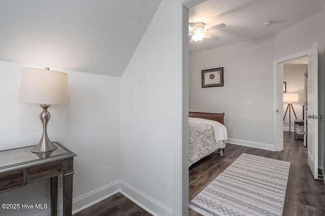 bedroom featuring dark wood-style floors, ceiling fan, lofted ceiling, and baseboards