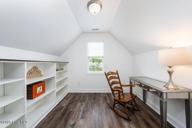 office area featuring dark wood-style floors, visible vents, vaulted ceiling, and baseboards
