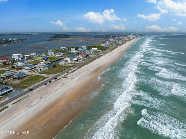 birds eye view of property featuring a beach view and a water view