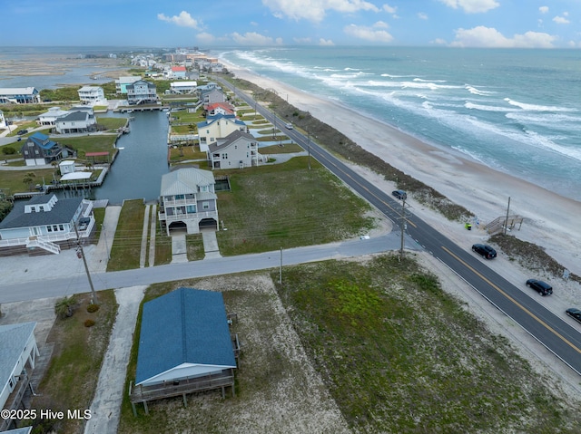 birds eye view of property with a view of the beach and a water view