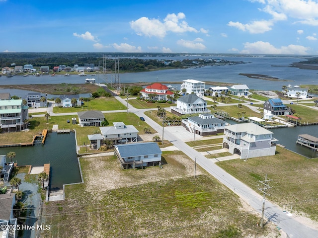 drone / aerial view featuring a residential view and a water view