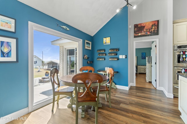 111 Waterway Ct, Aydlett, NC 27916 - dining space with baseboards, vaulted ceiling, and wood finished floors
