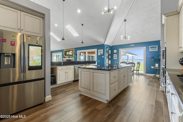 111 Waterway Ct, Aydlett, NC 27916 - kitchen featuring plenty of natural light, dark wood finished floors, vaulted ceiling with skylight, and stainless steel appliances