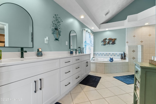 111 Waterway Ct, Aydlett, NC 27916 - bathroom with a sink, double vanity, tile patterned floors, lofted ceiling, and a garden tub