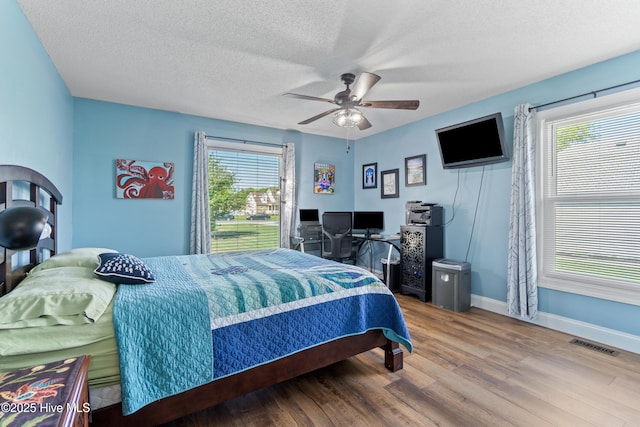 111 Waterway Ct, Aydlett, NC 27916 - bedroom with a ceiling fan, a textured ceiling, visible vents, wood finished floors, and baseboards