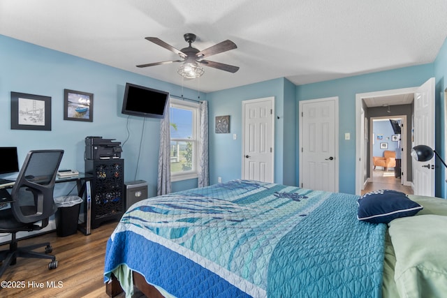111 Waterway Ct, Aydlett, NC 27916 - bedroom featuring a ceiling fan, a textured ceiling, wood finished floors, and attic access