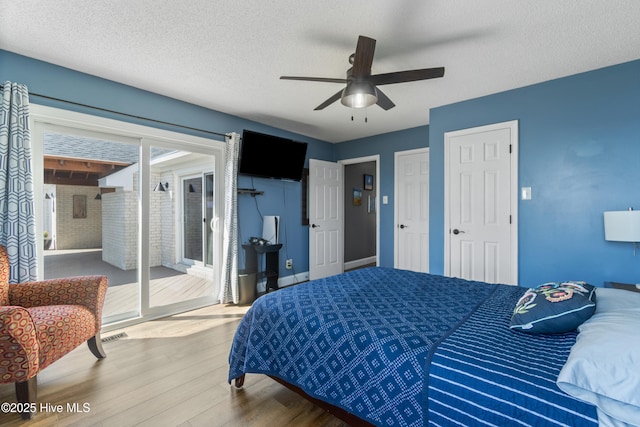 111 Waterway Ct, Aydlett, NC 27916 - bedroom featuring ceiling fan, a textured ceiling, access to outside, and wood finished floors