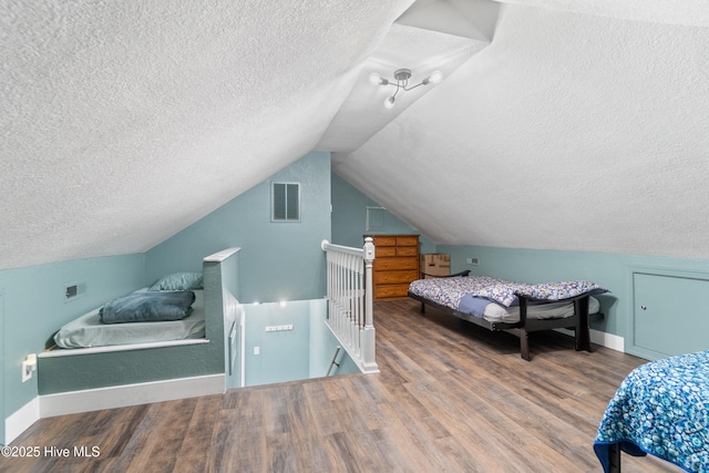 111 Waterway Ct, Aydlett, NC 27916 - bedroom with visible vents, a textured ceiling, wood finished floors, and vaulted ceiling