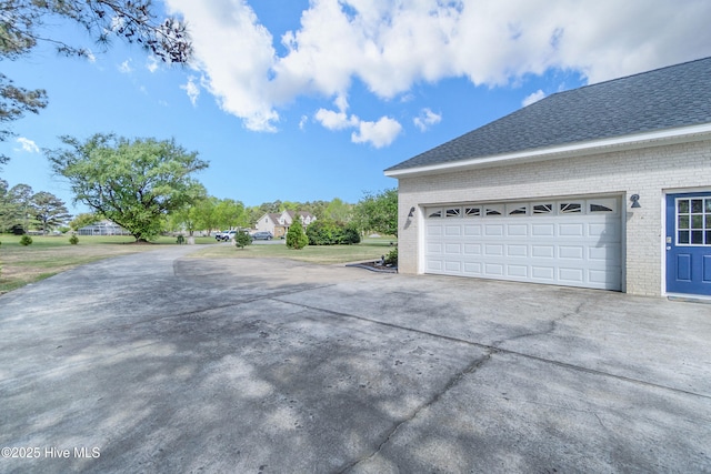 111 Waterway Ct, Aydlett, NC 27916 - view of property exterior with brick siding, a shingled roof, and driveway