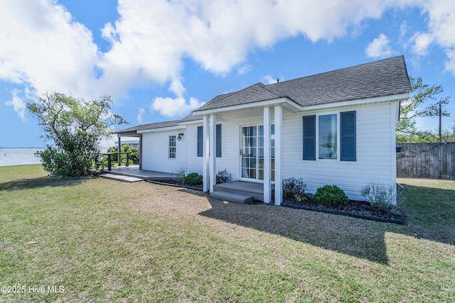111 Waterway Ct, Aydlett, NC 27916 - rear view of property featuring fence, a lawn, and roof with shingles