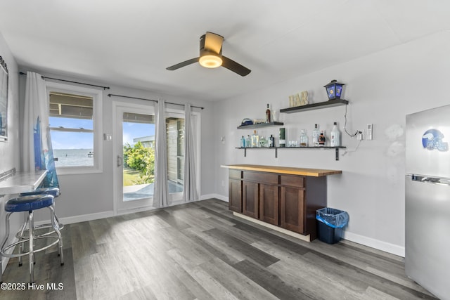 111 Waterway Ct, Aydlett, NC 27916 - bar with ceiling fan, freestanding refrigerator, a bar, and wood finished floors
