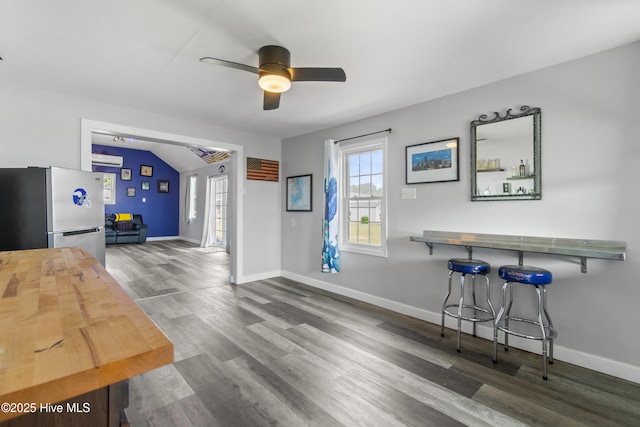 111 Waterway Ct, Aydlett, NC 27916 - dining space with a ceiling fan, baseboards, a wall mounted AC, and wood finished floors