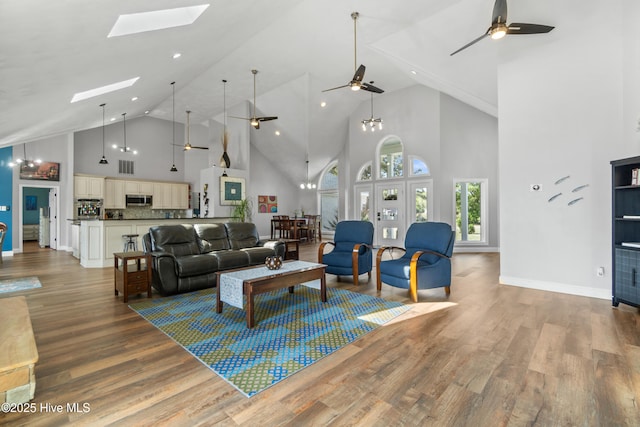 111 Waterway Ct, Aydlett, NC 27916 - living area featuring a skylight, high vaulted ceiling, ceiling fan, and light wood-style flooring
