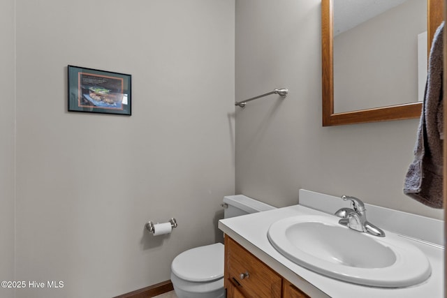 half bathroom featuring toilet and vanity