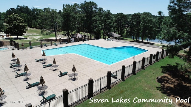 pool with fence, a yard, and a patio