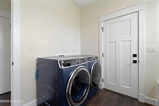laundry room featuring dark wood-style floors, washer and clothes dryer, and laundry area