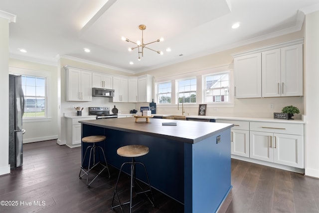 kitchen featuring a center island, crown molding, stainless steel range with electric stovetop, a notable chandelier, and freestanding refrigerator
