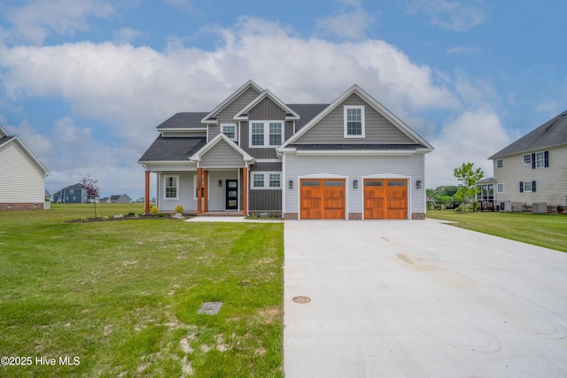 craftsman-style home with concrete driveway, a front lawn, a garage, and covered porch