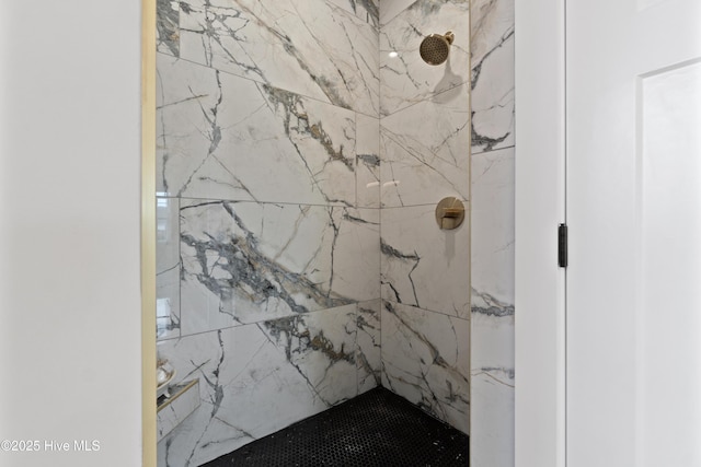 bathroom with a marble finish shower